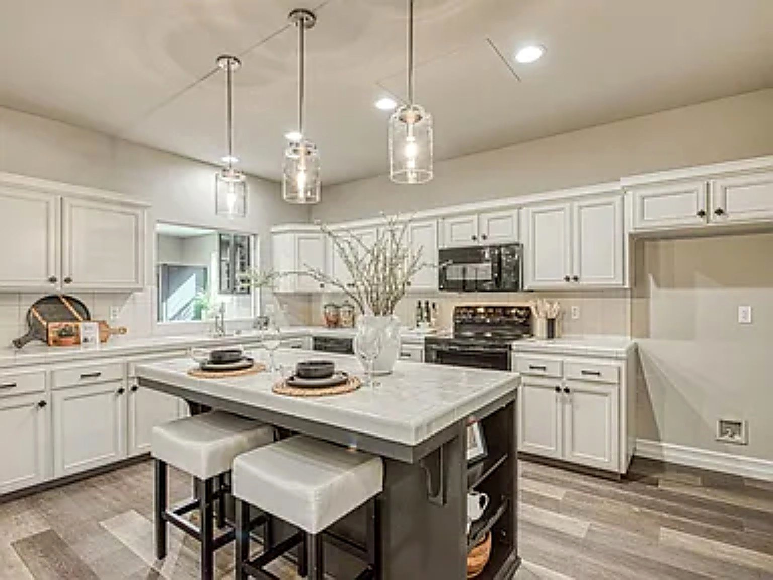 Finished kitchen with custom cabinetry, island and warm wood accents