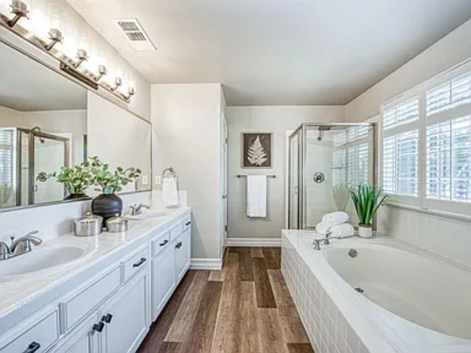 Finished primary bathroom remodel with freestanding tub and tiled shower