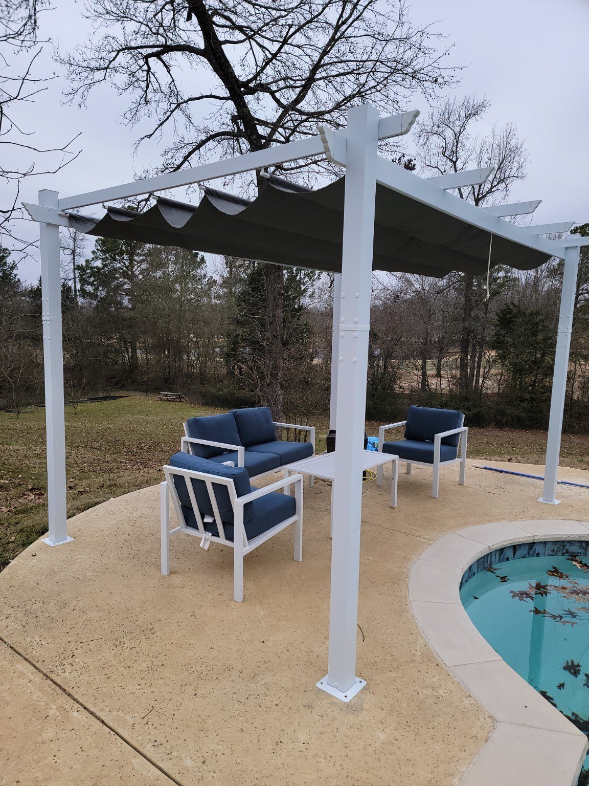 Residential poolside area with a wood pergola