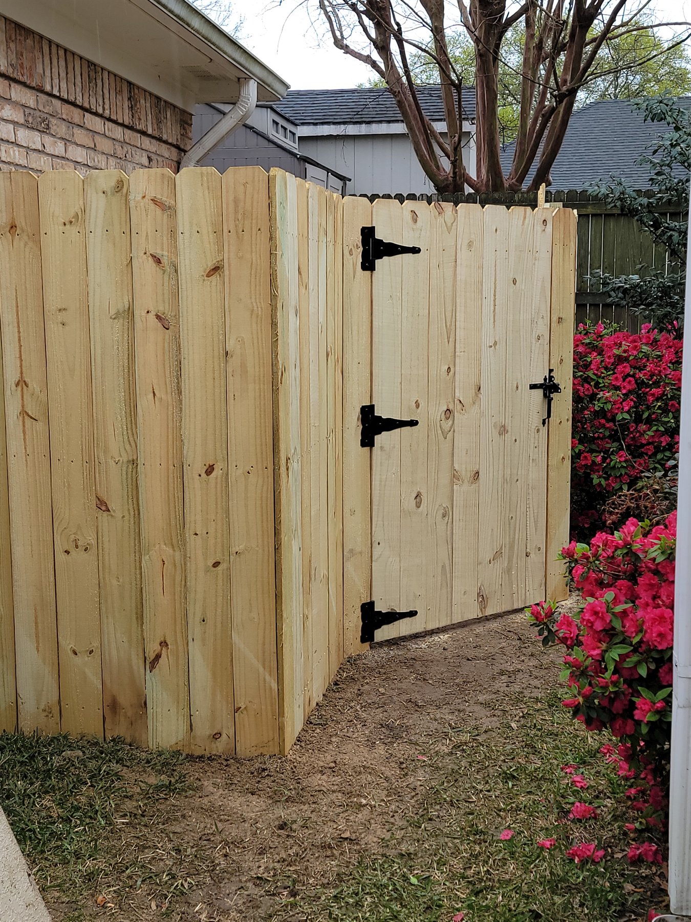 Finished wood privacy fence corner and access gate
