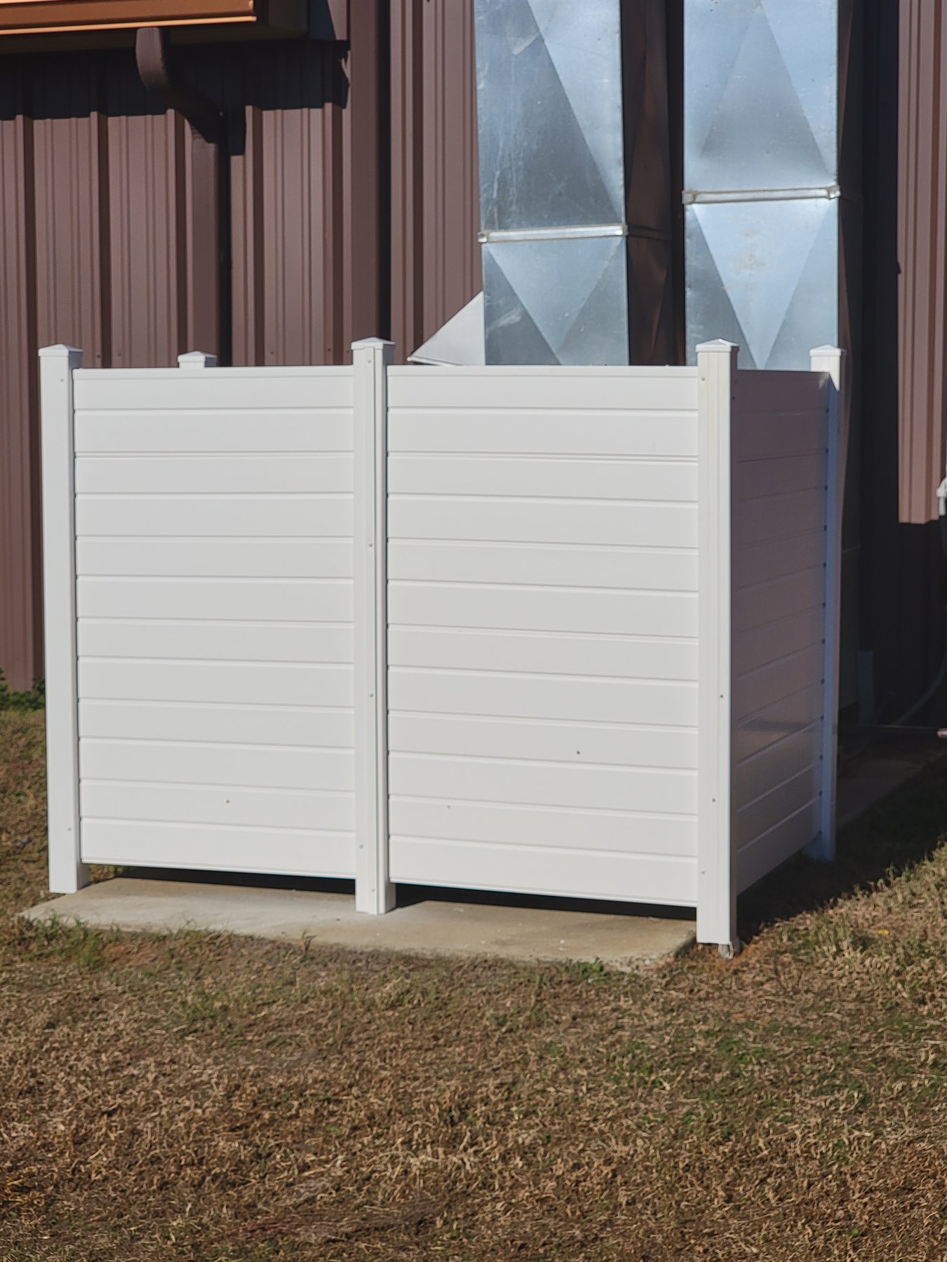Wood privacy fencing built around an outdoor air-conditioning area